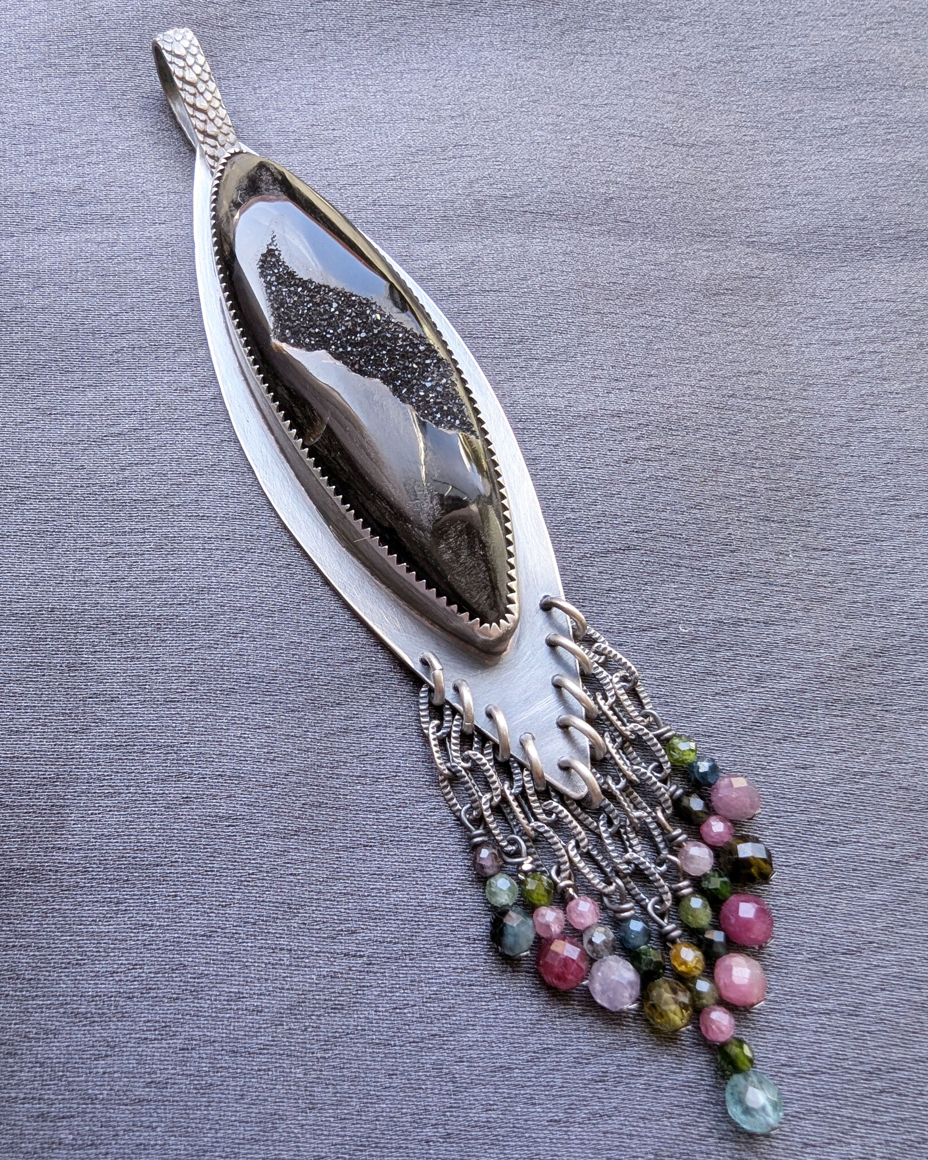 celestial inspired pendant with black stone and subtle sparkle