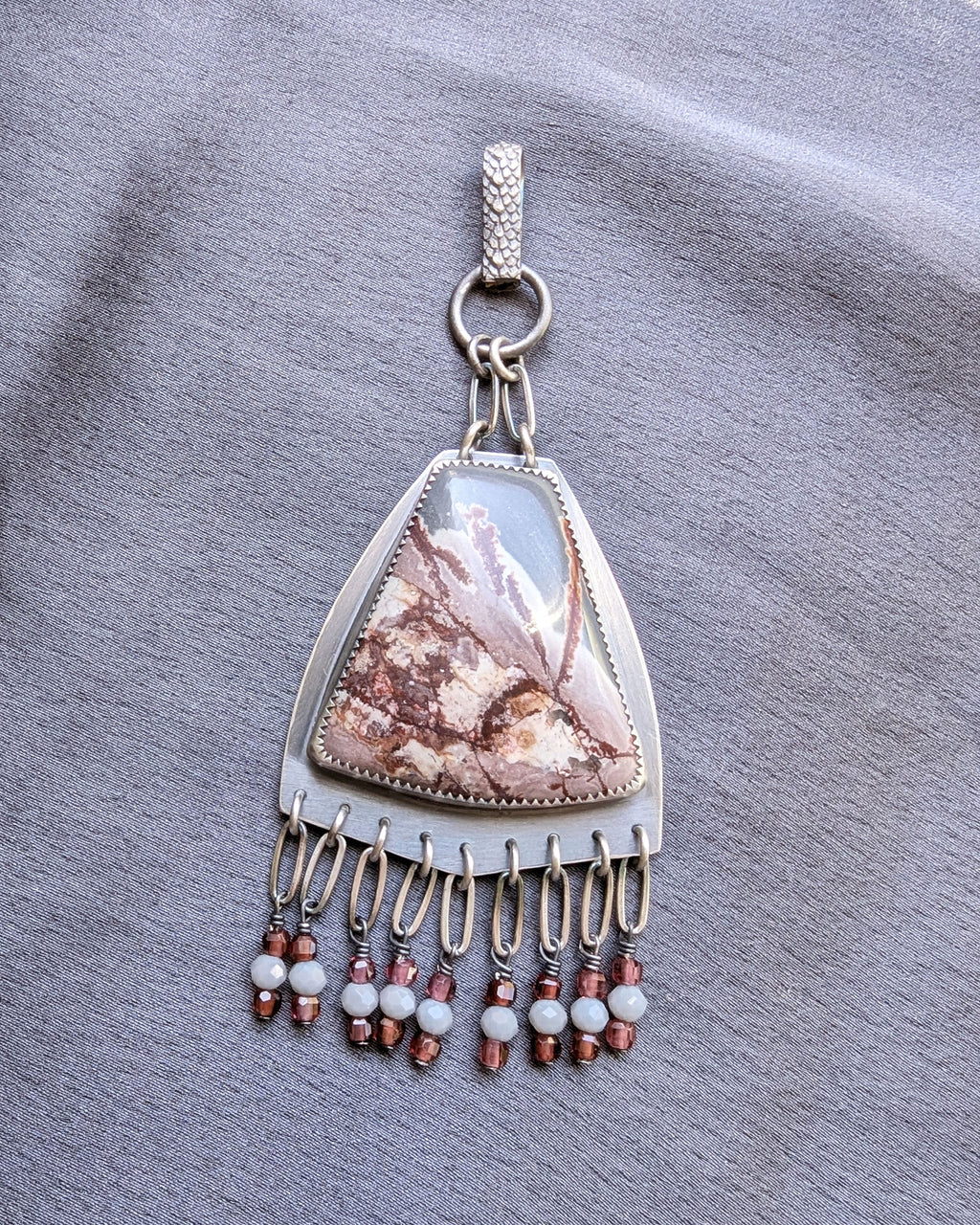 rhyolite pendant with garnet fringe in oxidized sterling silver