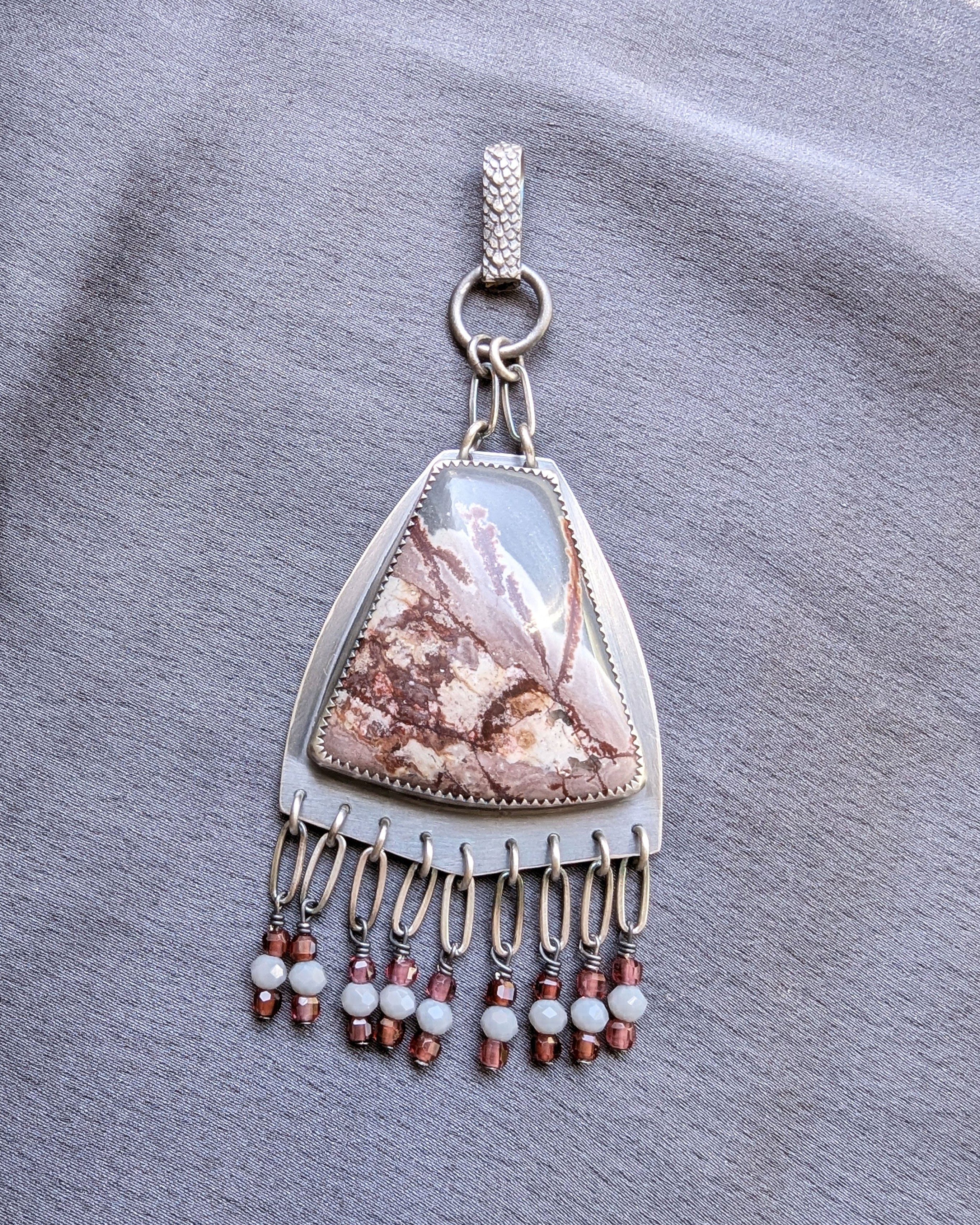 rhyolite pendant with garnet fringe in oxidized sterling silver