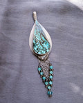 artisan silver pendant with blue and brown gemstone pattern