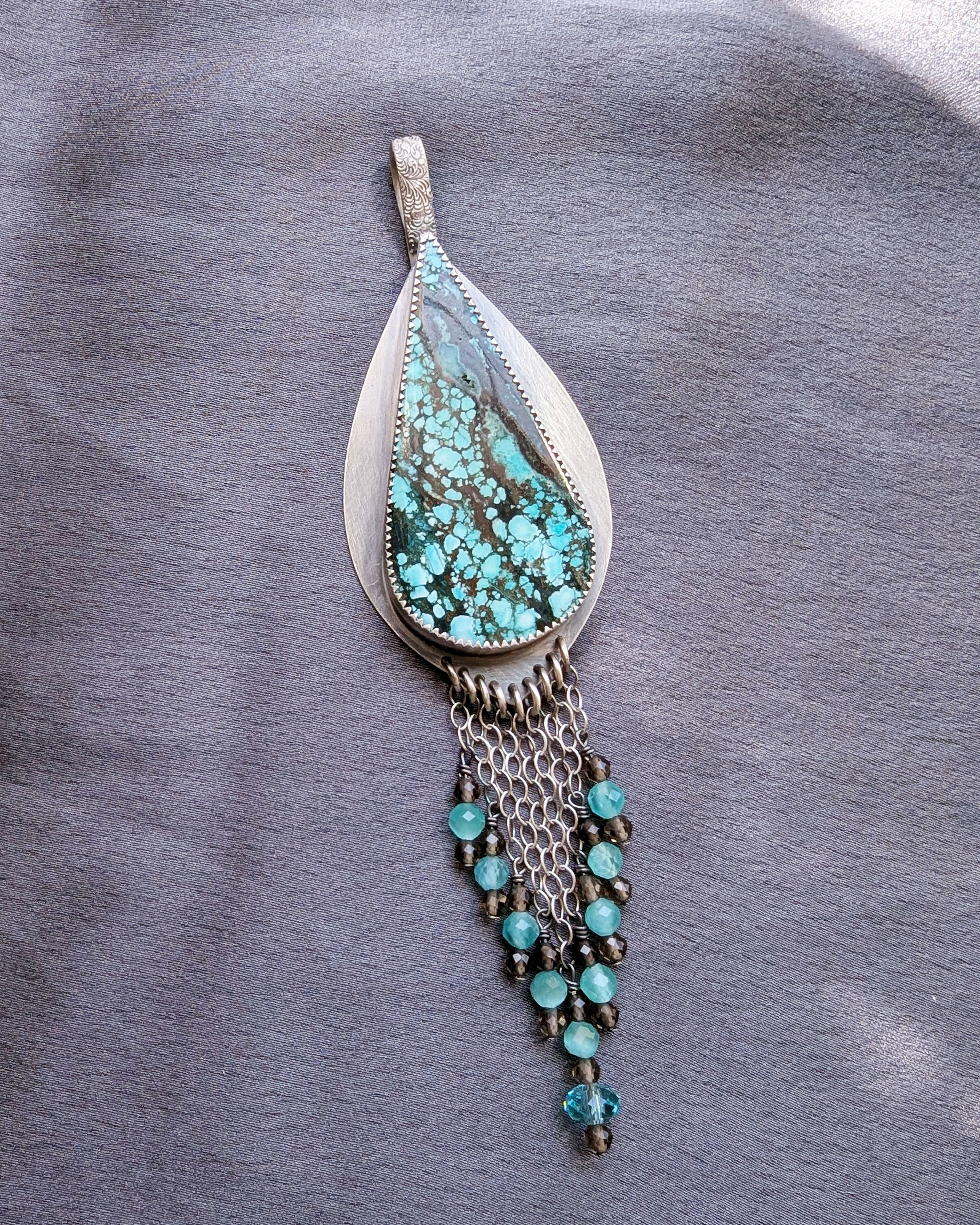 artisan silver pendant with blue and brown gemstone pattern