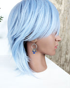 artisan hoop earrings with blue lapis gemstone and leaf drops on bust for scale