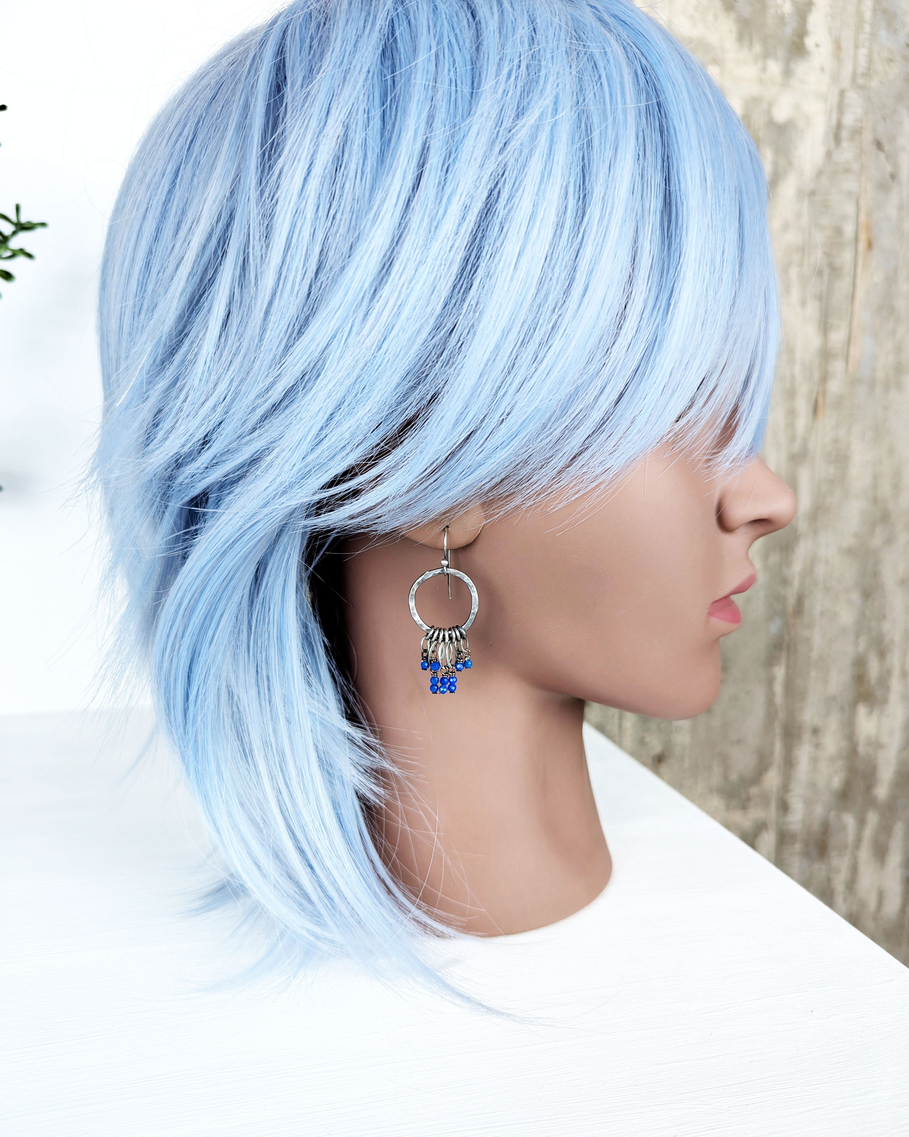 artisan hoop earrings with blue lapis gemstone and leaf drops on bust for scale