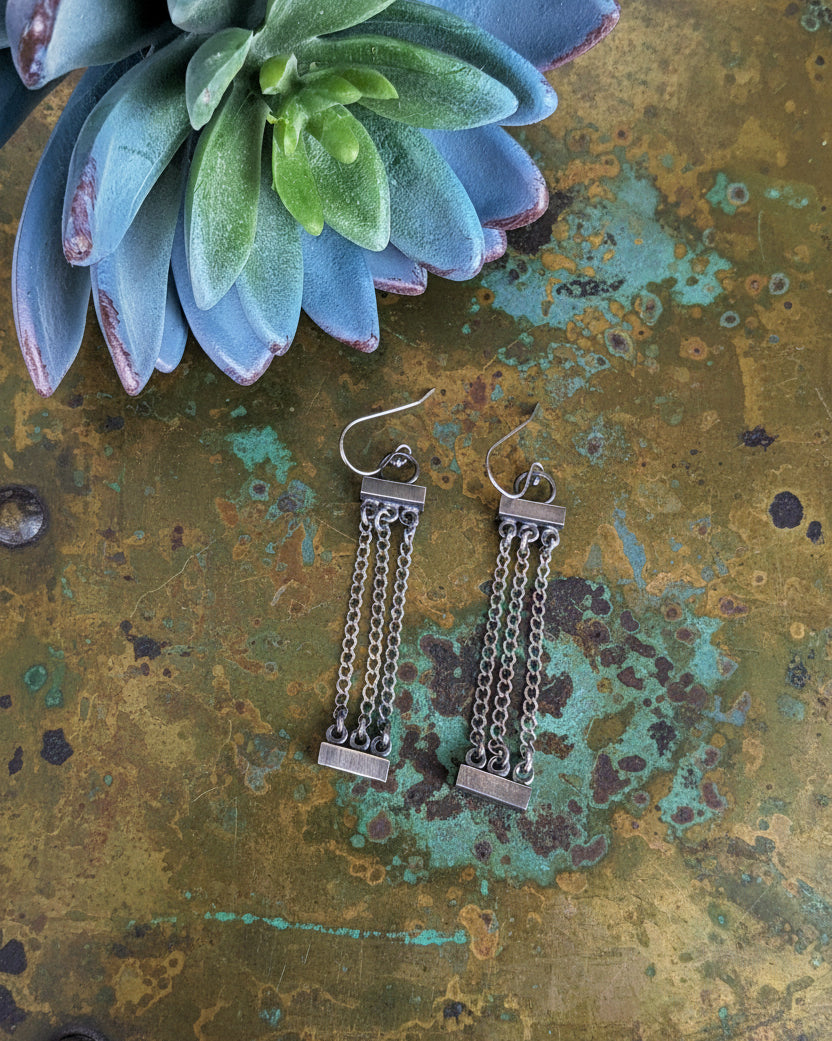 modern minimalist silver earrings with architectural style
