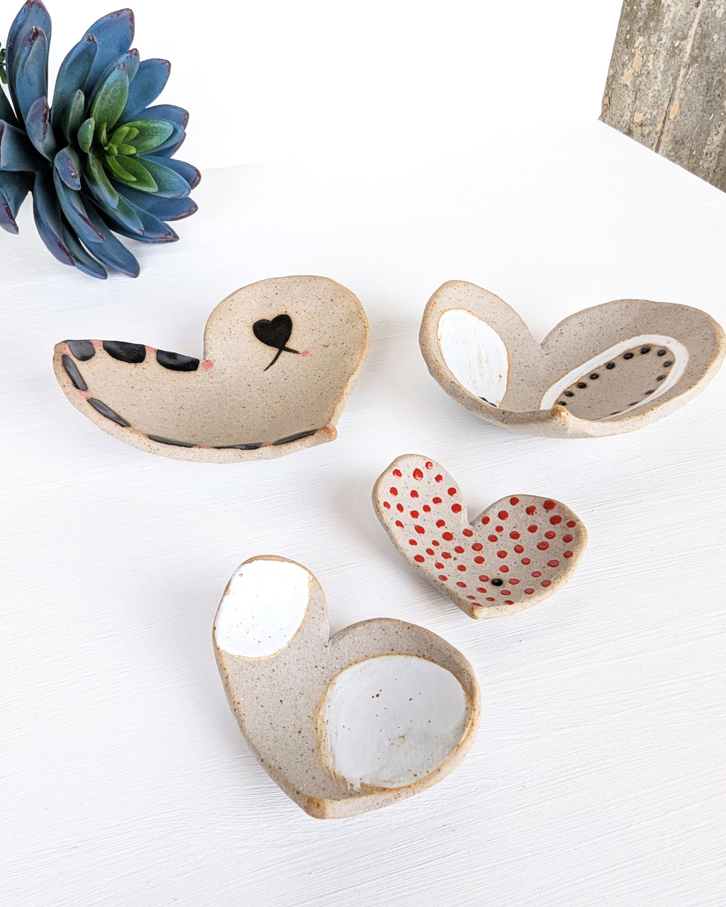 Handmade nesting heart jewelry dish set crafted from rustic stoneware, a thoughtful artisan pottery gift for jewelry lovers and collectors.