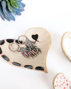 Set of four handmade stoneware nesting heart jewelry dishes with hand-painted one-of-a-kind designs in rustic speckled clay by Rebellenhaus.