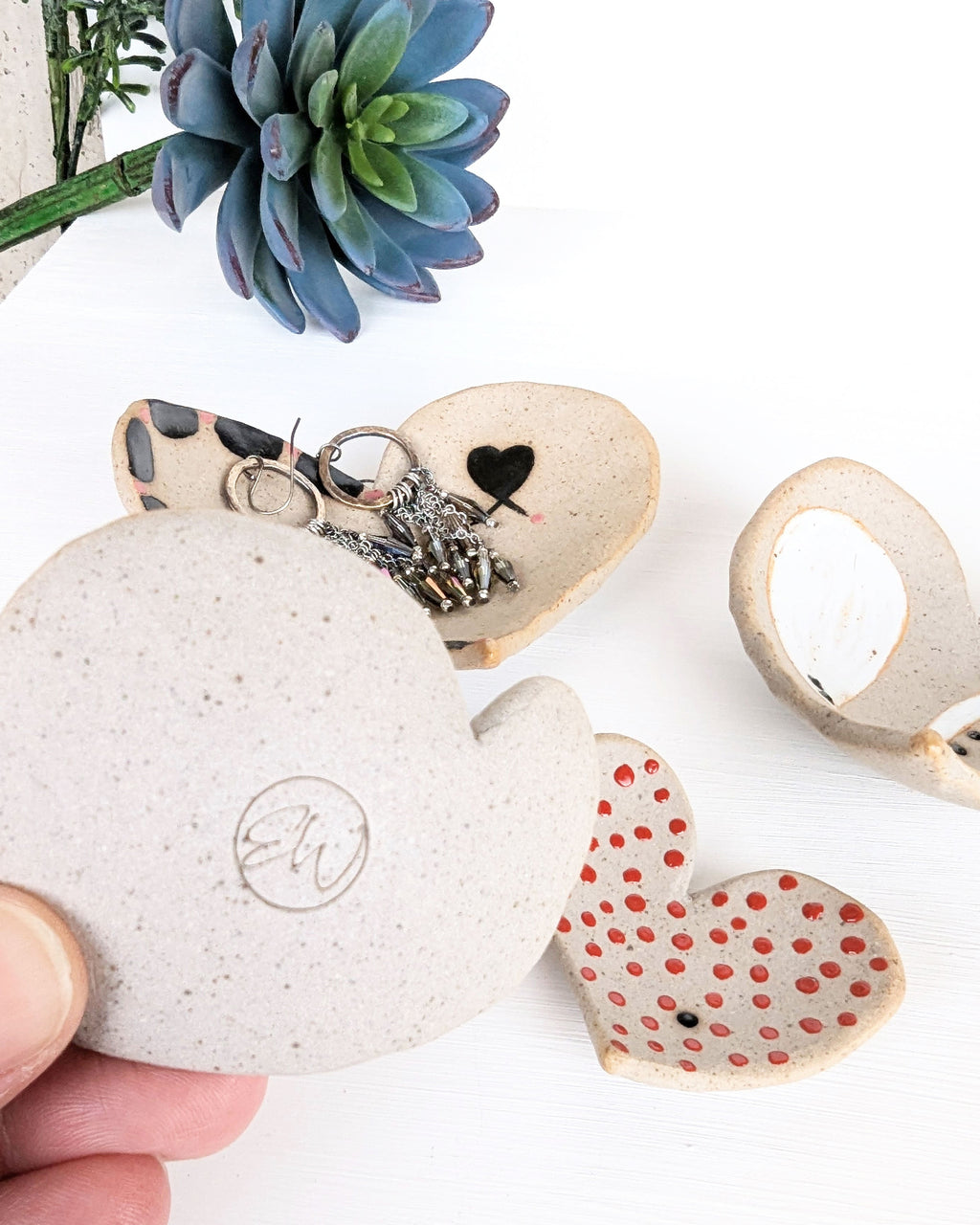 Hand-built stoneware heart dish featuring a unique hand-painted design on warm speckled clay, perfect as a ring dish or jewelry bowl with maker's mark, EW.