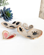 Rustic ceramic nesting heart bowls with modern painted designs for jewelry storage.