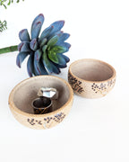 Hand-thrown stoneware jewelry bowls featuring black dotted aspen tree designs on warm natural clay.