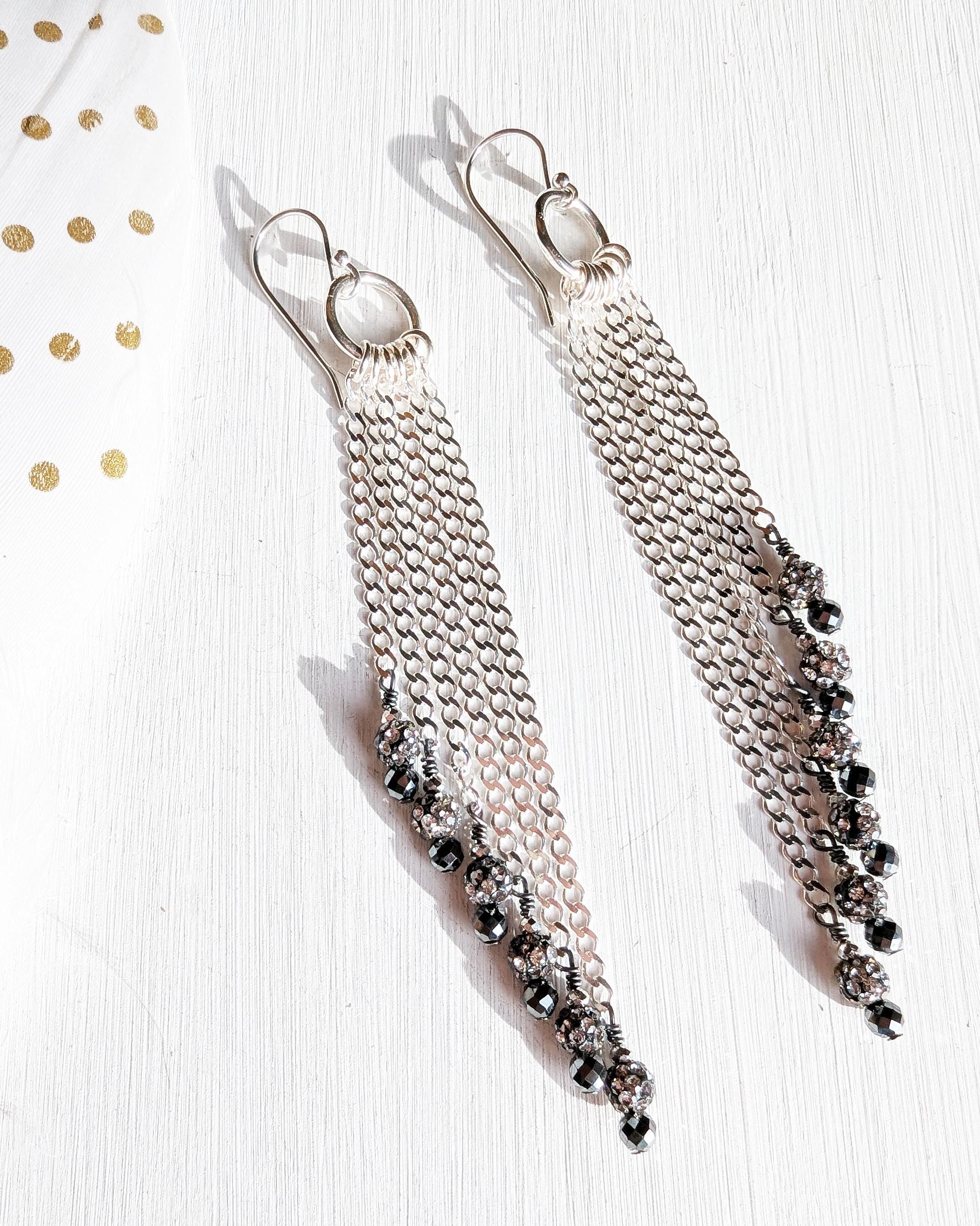 Edgy glam earrings with cascading silver chain movement