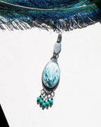 Artisan green gemstone pendant necklace handmade in sterling silver in bright sunlight