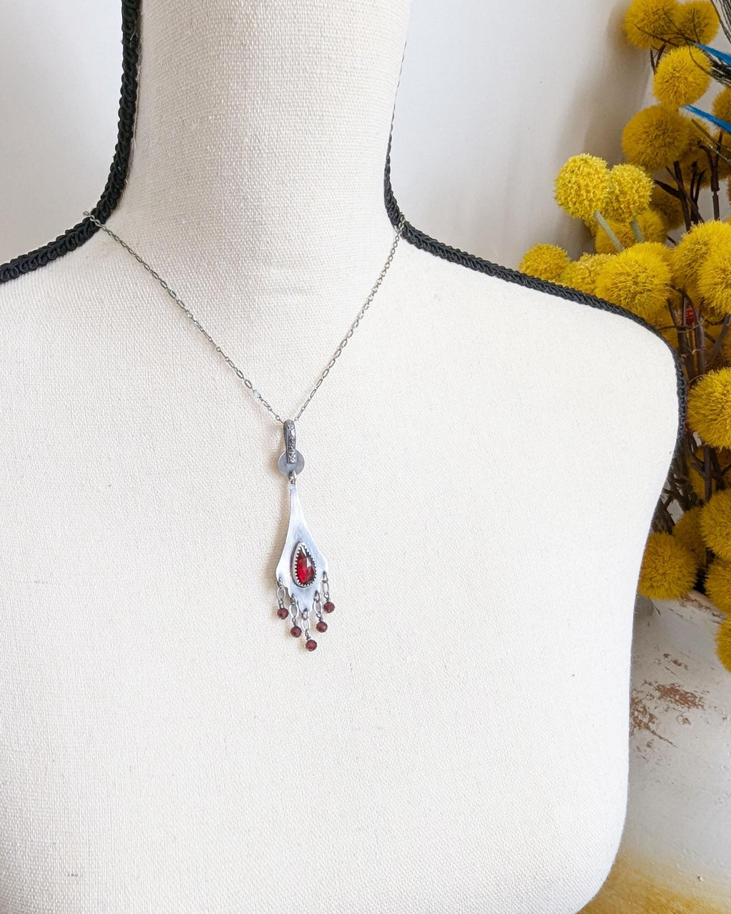 Vintage-style gemstone pendant with feminine curved silhouette