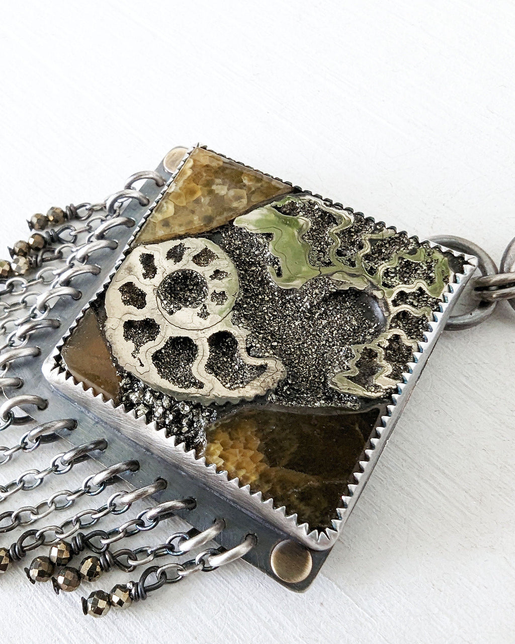 Close up of main stone ammonite, pyrite and simbircite mosaic