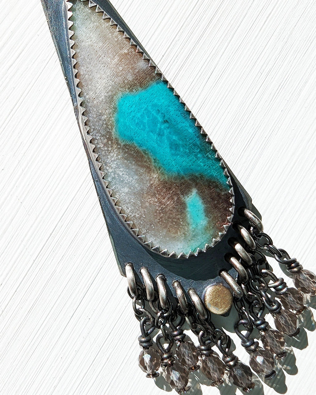Close up of opalized wood stone with abstract turquoise patterns