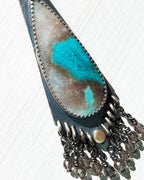 Close up of opalized wood stone with abstract turquoise patterns