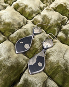 Black and gold pyrite statement earrings with asymmetrical natural patterning