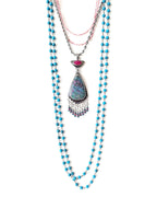 Colorful ruby in kyanite pendant shown on chain with other layering necklaces for styling