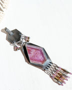Asymmetrical artisan pendant featuring natural ruby stone