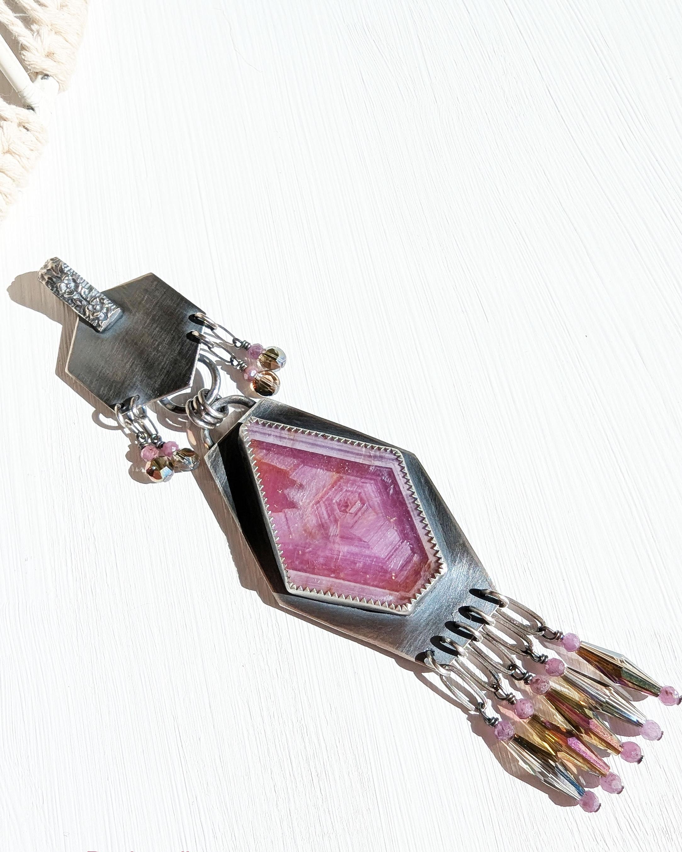 Asymmetrical artisan pendant featuring natural ruby stone