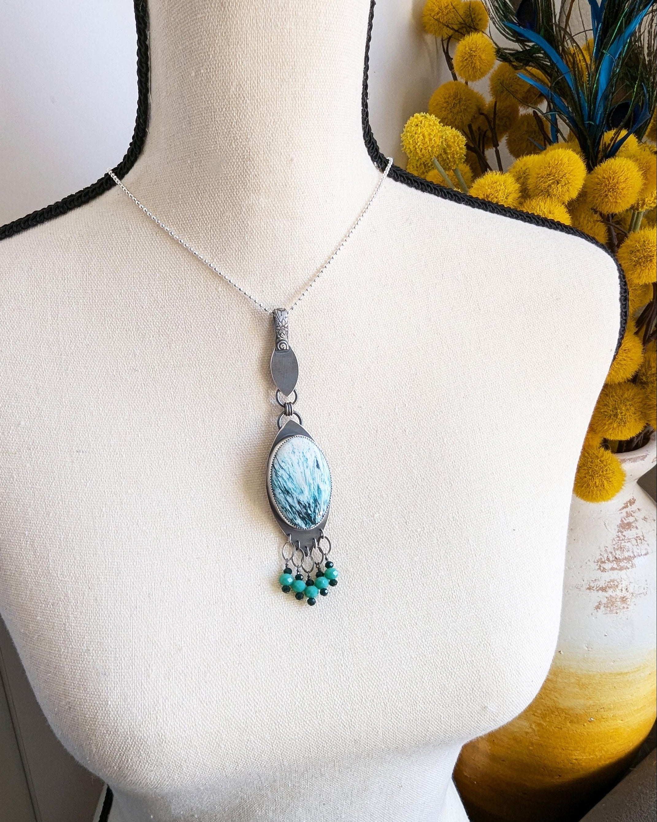 Artisan green gemstone pendant necklace handmade in sterling silver shown on bust for size in natural light