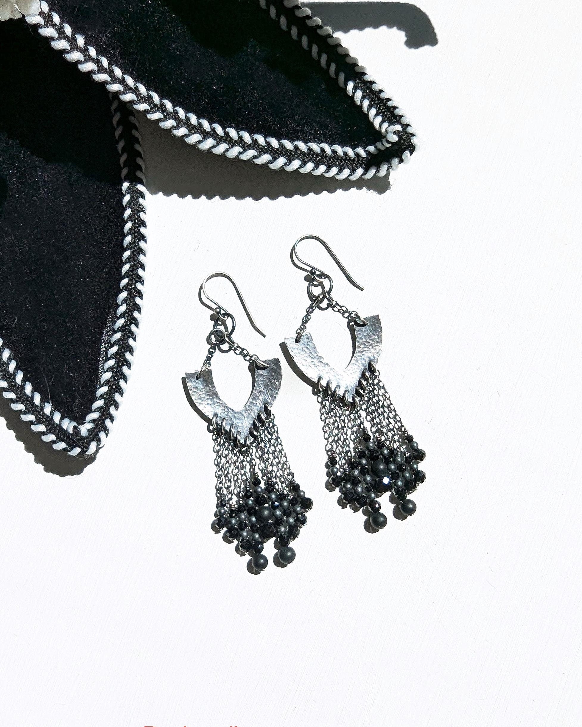 Black chandelier earrings in oxidized sterling silver with vintage glass and spinel on white background
