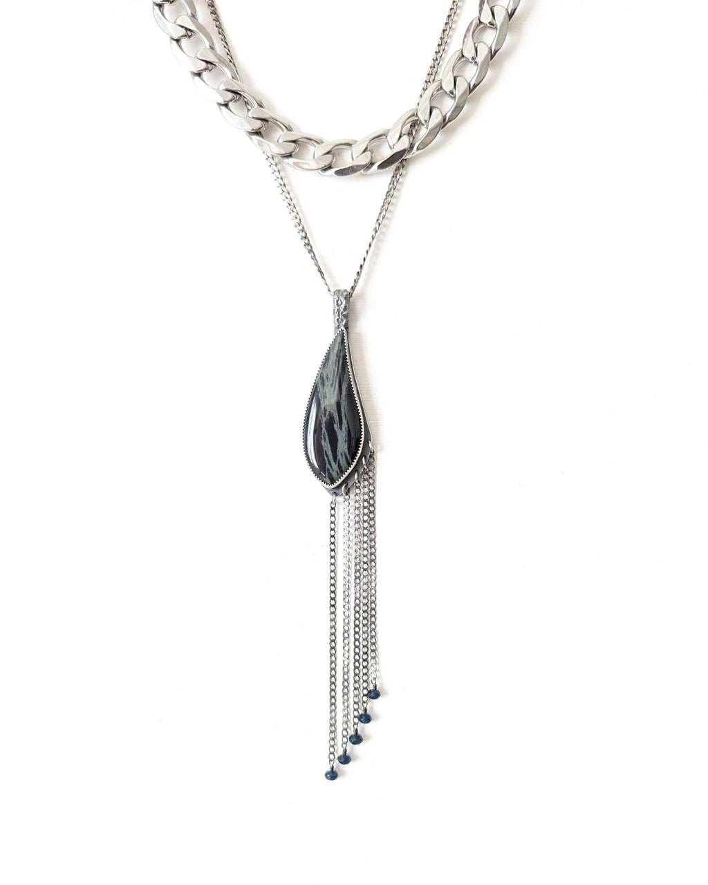 Necklace with a leaf-shaped pendant and chain on a white background