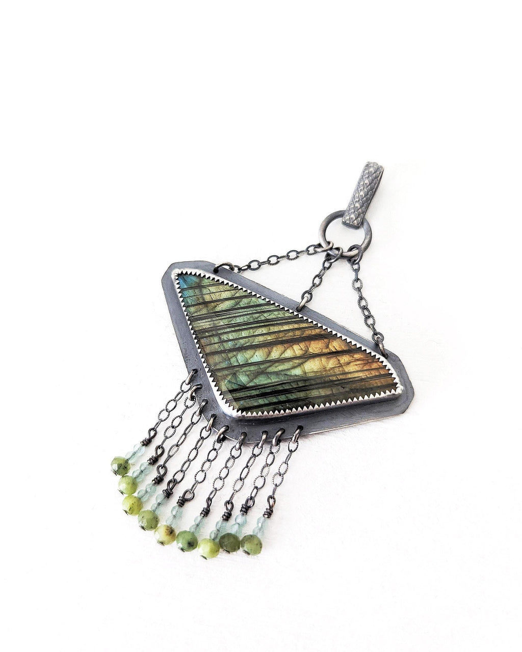 Close-up of rose-cut labradorite showing blue, gold, and green iridescent flash
