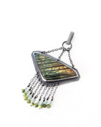Close-up of rose-cut labradorite showing blue, gold, and green iridescent flash
