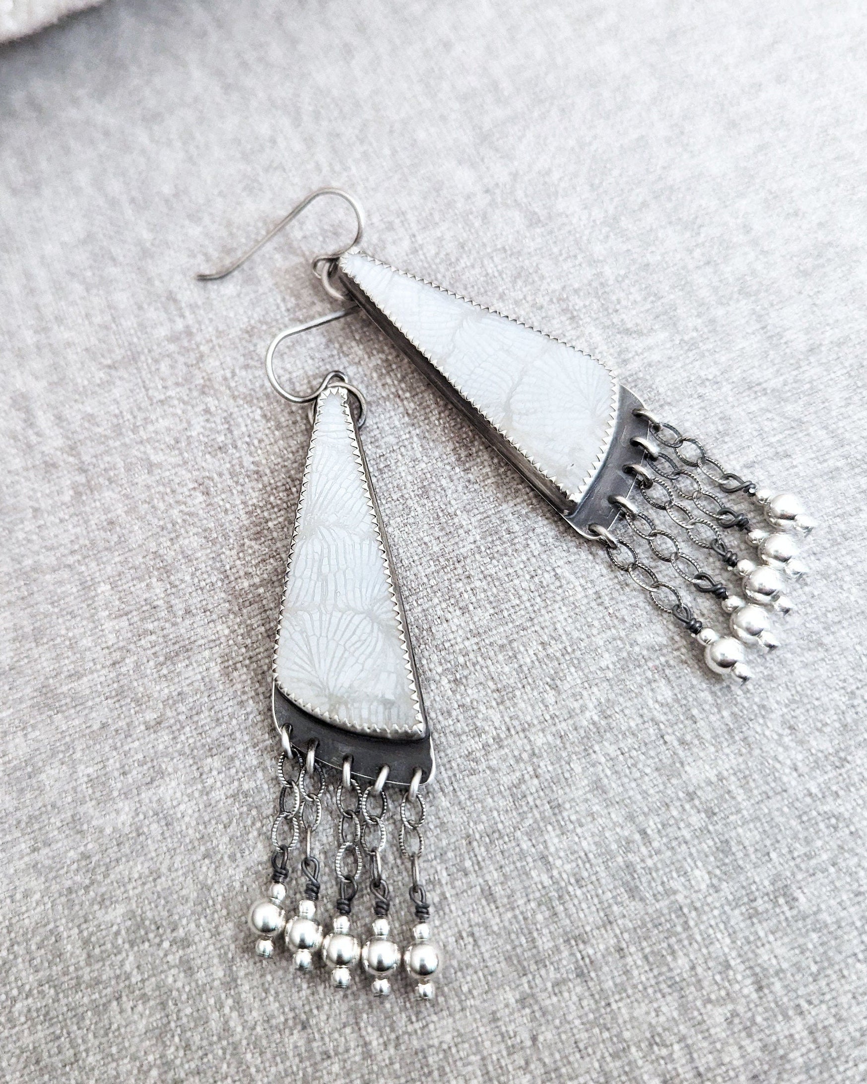 Oceanic artisan earrings featuring fossilized coral detail
