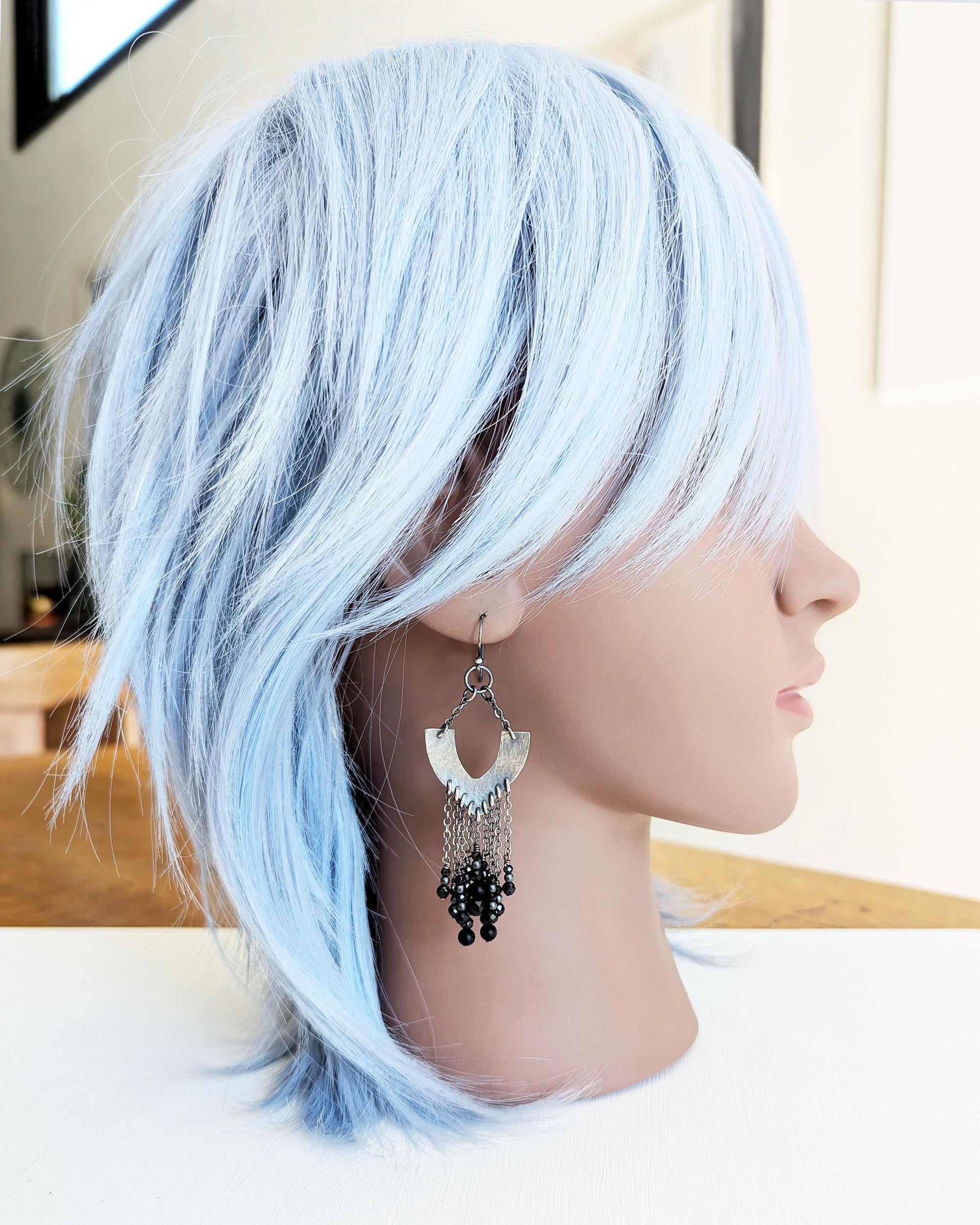 Handcrafted black chandelier earrings worn for scale on mannequin
