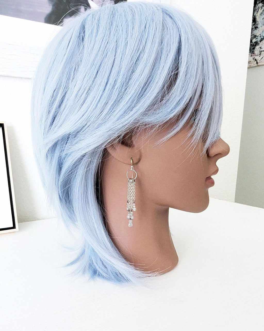 Lightweight artisan earrings with labradorite beads and swaying chain fringe on a mannequin for scale