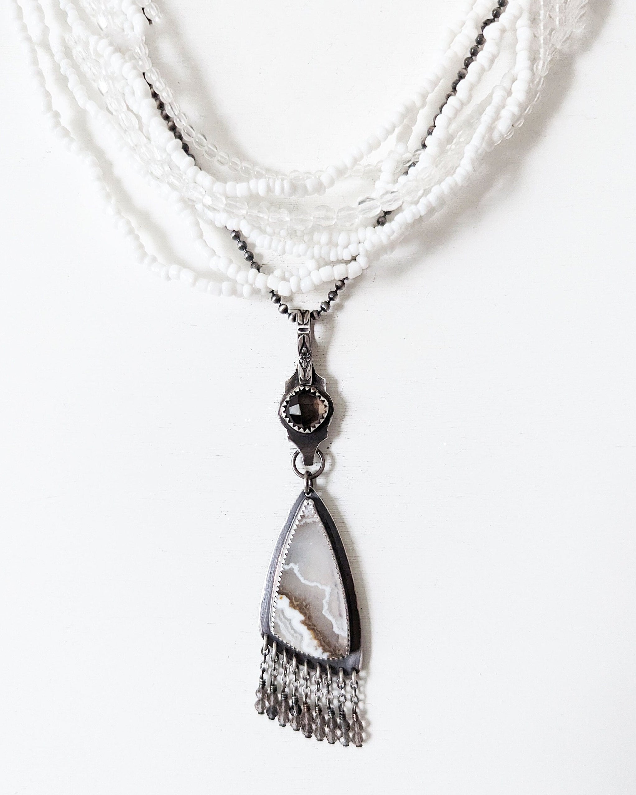 Neutral gemstone statement pendant with soft white and brown tones shown on chain and layer necklace (not Included)