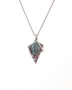 Handcrafted rainbow fluorite and garnet pendant by Rebellenhaus shown on chain (not included)