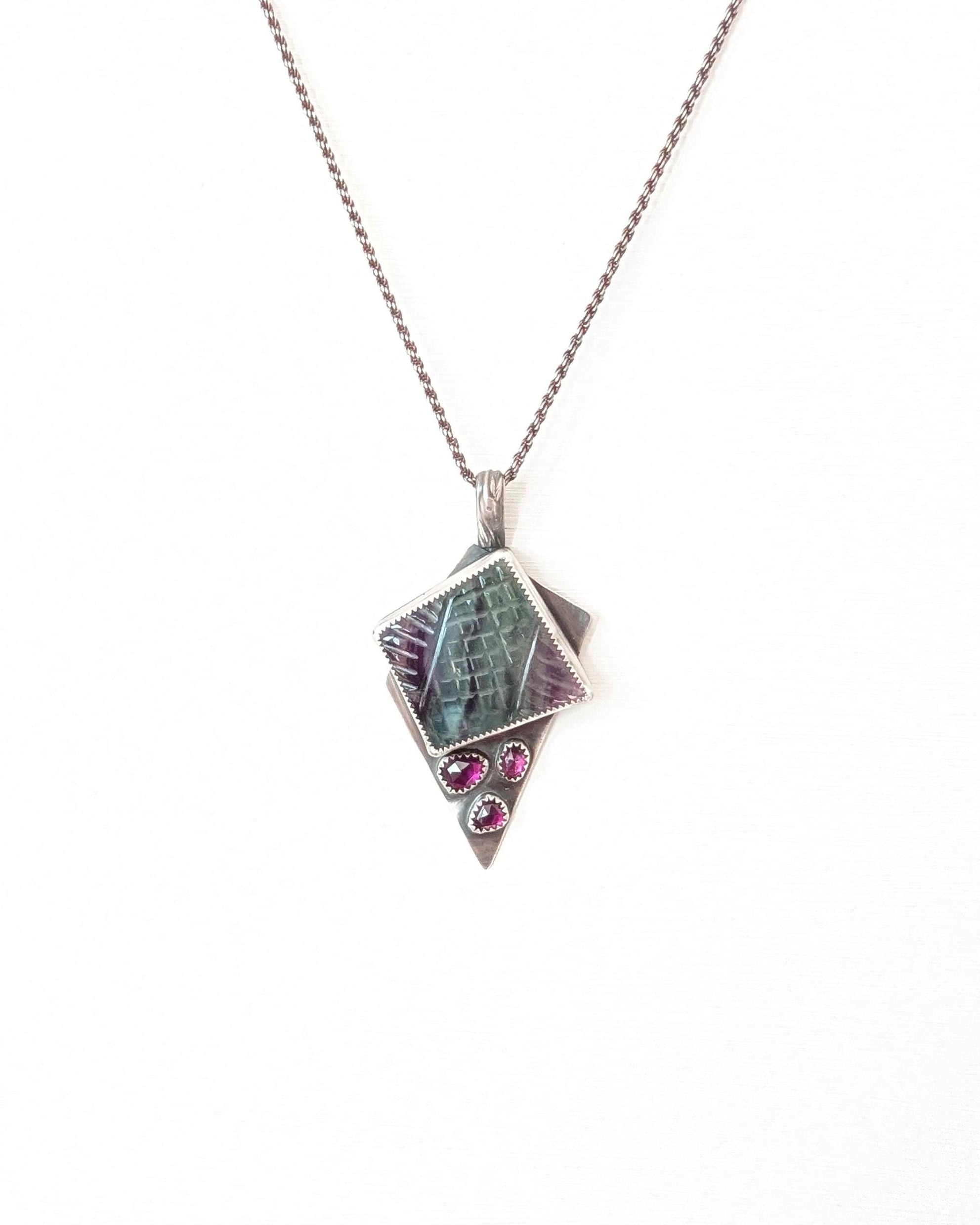 Handcrafted rainbow fluorite and garnet pendant by Rebellenhaus shown on chain (not included)