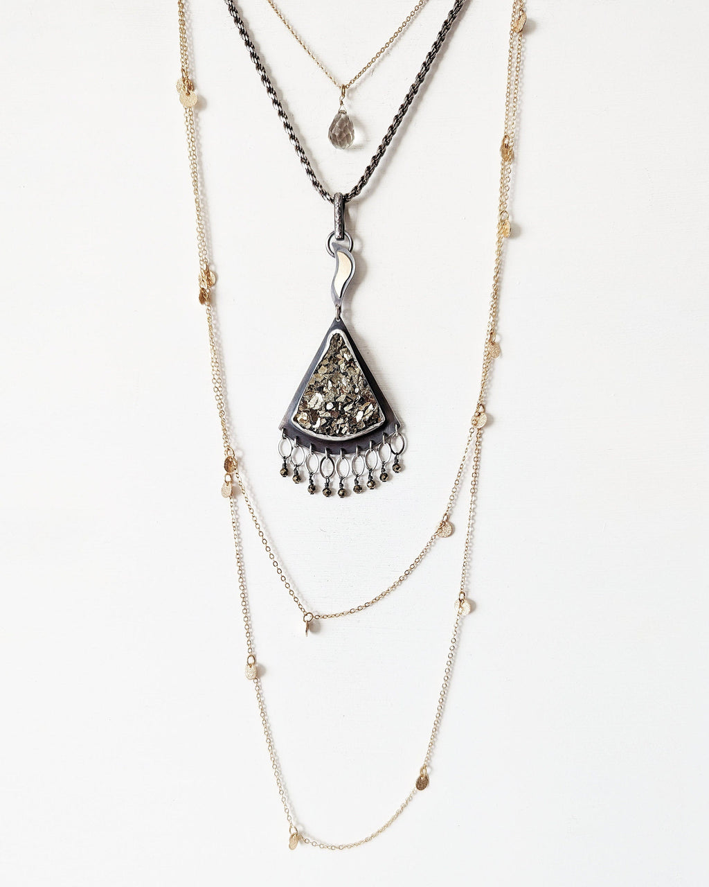 Artisan mixed metal pendant featuring triangular druzy pyrite and flame bail shown on chain with layering necklaces for styling