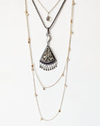 Artisan mixed metal pendant featuring triangular druzy pyrite and flame bail shown on chain with layering necklaces for styling