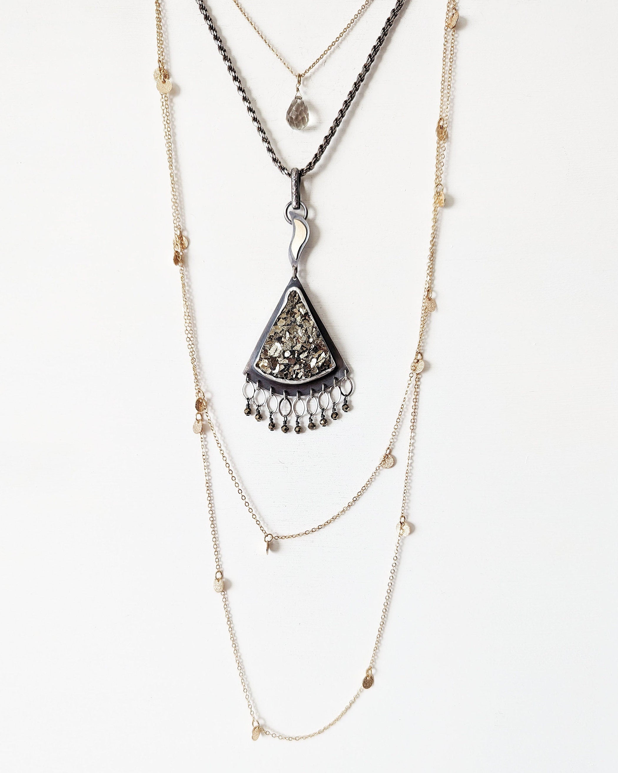 Artisan mixed metal pendant featuring triangular druzy pyrite and flame bail shown on chain with layering necklaces for styling
