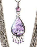 Close up of charoite and amethyst two stone pendant