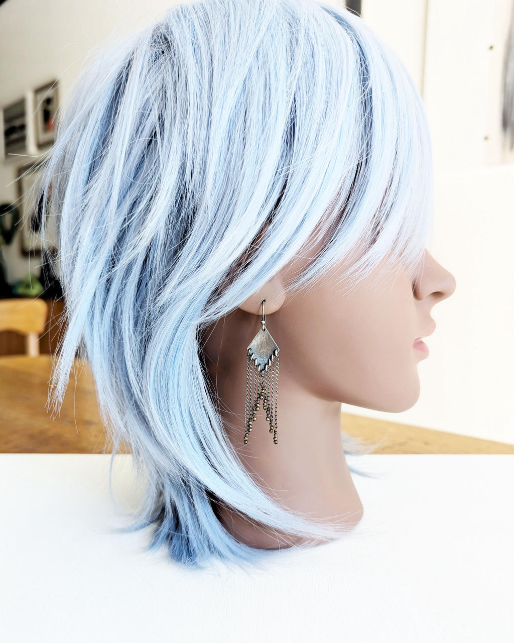 Handcrafted pyrite fringe earrings worn for scale on mannequin
