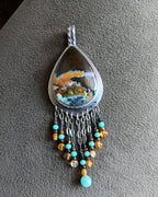 Pear-shaped opalized wood stone with aqua and burnt orange tones