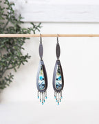 Pair of earrings with a decorative design on a white background