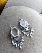 Close-up of hydro quartz crystals framed in oxidized sterling silver earrings
