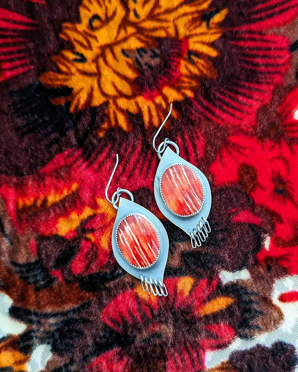 Southwest statement earrings with coral and crimson shell tones