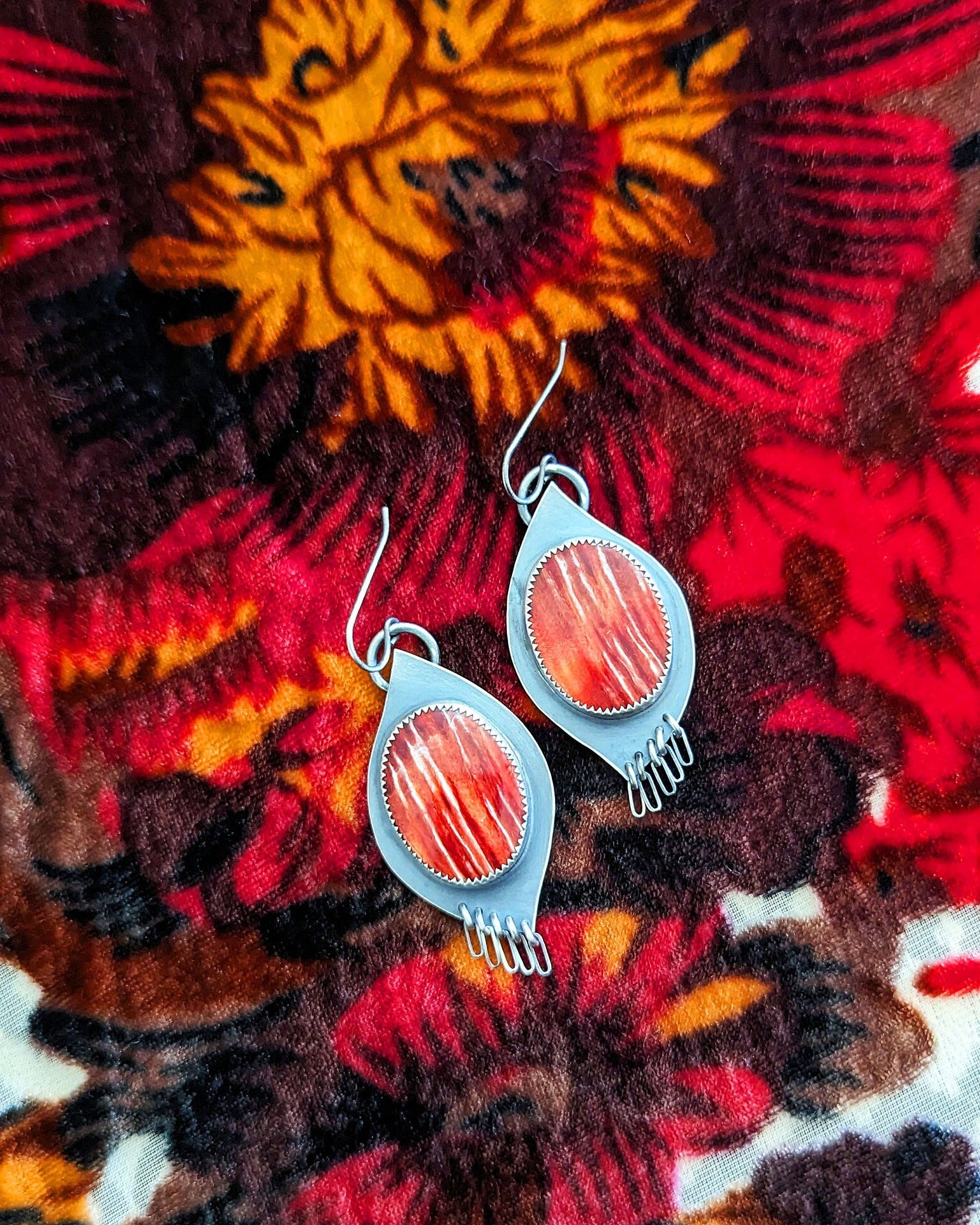 Southwest statement earrings with coral and crimson shell tones