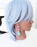 Collector gemstone earrings with vibrant magenta and turquoise contrast
