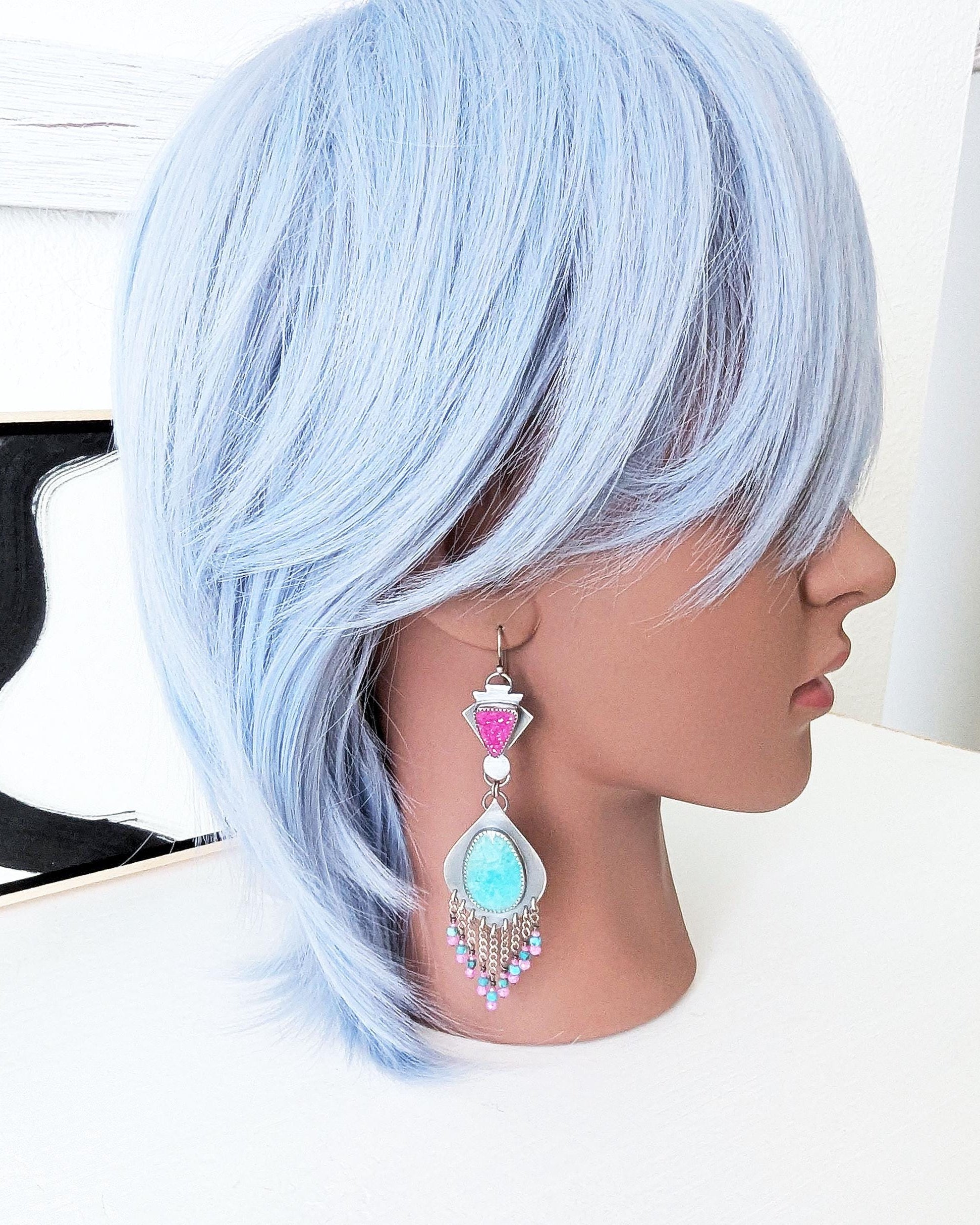 Collector gemstone earrings with vibrant magenta and turquoise contrast