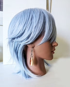 Collector gemstone earrings with vertically striped agate centerpiece on mannequin for scale