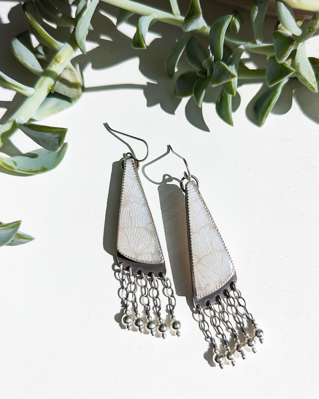 Fossil coral earrings with translucent white snowflake patterns
