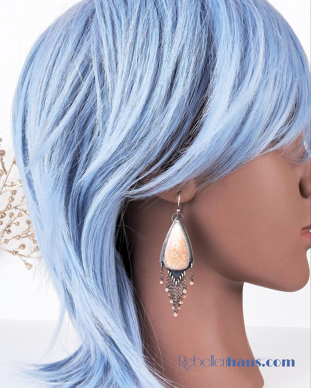 Artisan handmade scolecite earrings with feminine yet edgy design on mannequin for scale