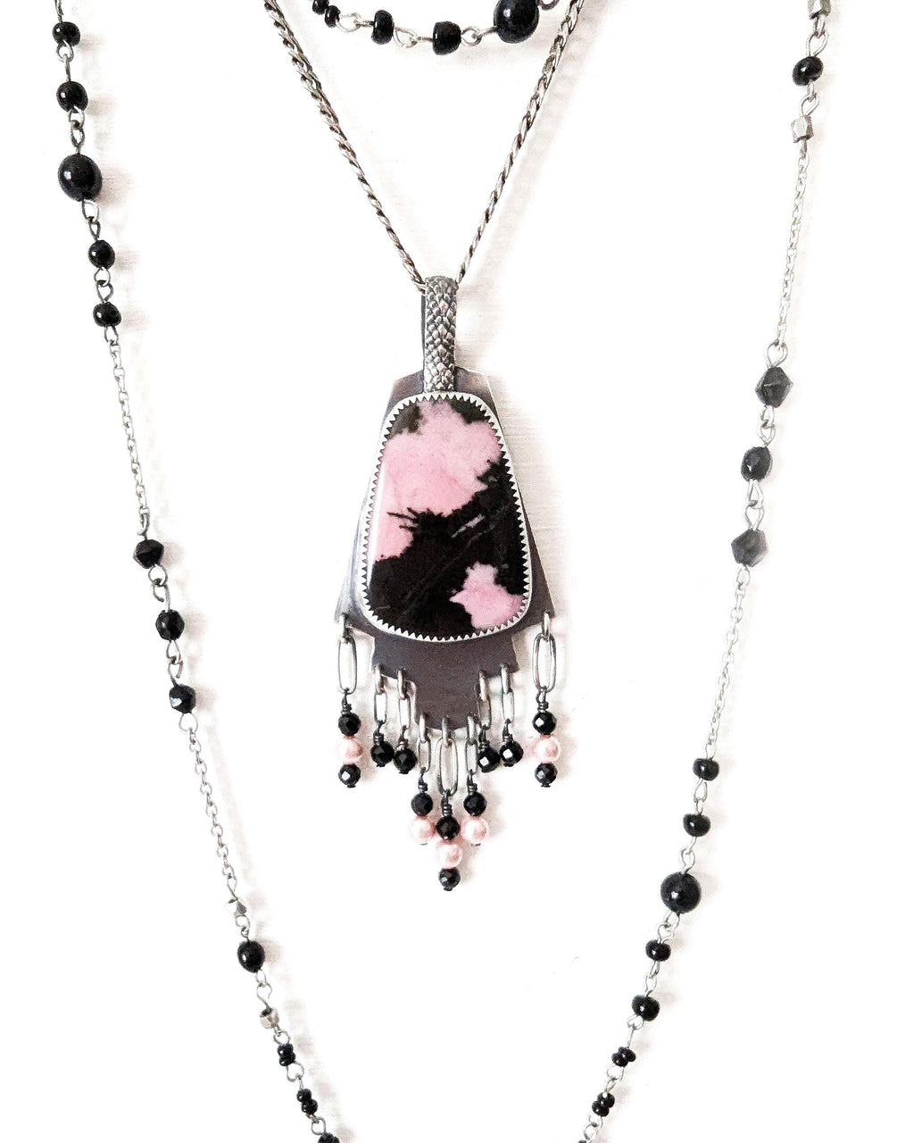 Rhodonite pendant with pink and black pattern in oxidized sterling silver shown on chain with layering necklace (not included)